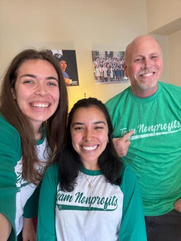 Three Angel Oak Creative staff wearing their Team Nonprofits shirts