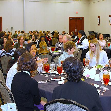 Participants chatting during lunch at the conference.