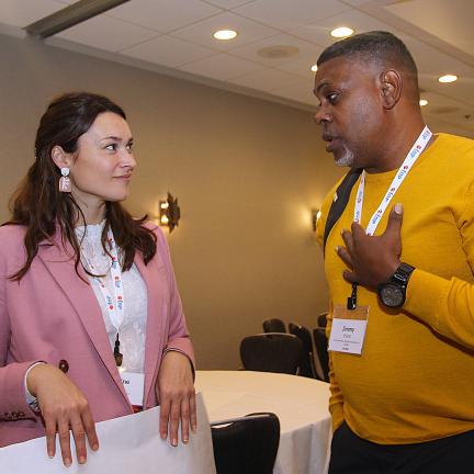 Presenter and participant talking after the session during the conference.