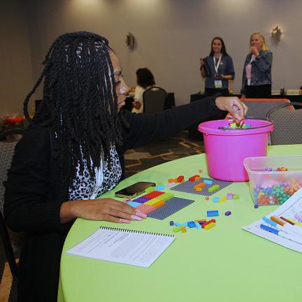 Participant taking a break in the Marbles Play & Recharge room during the 2025 conference.